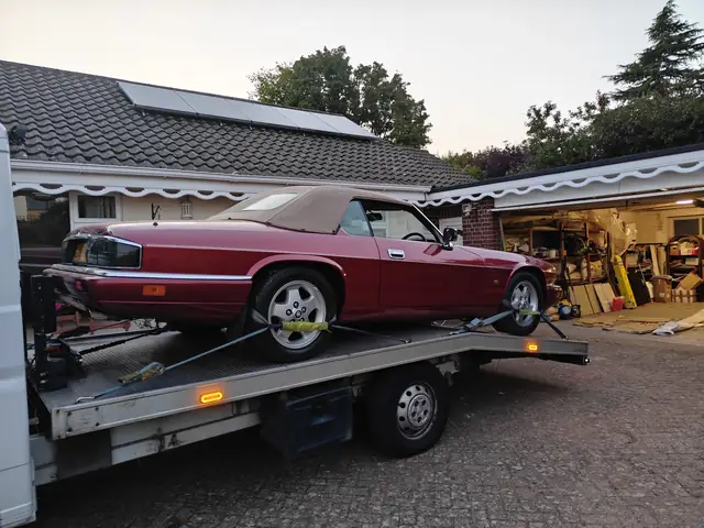 Red Jaguar XJS convertible on the recovery truck, photo from this review