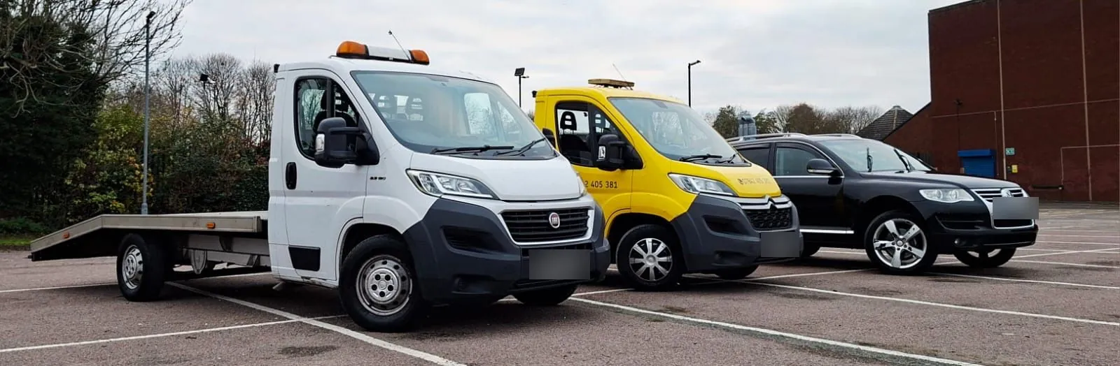 The fleet: white truck, yellow truck and the Touareg