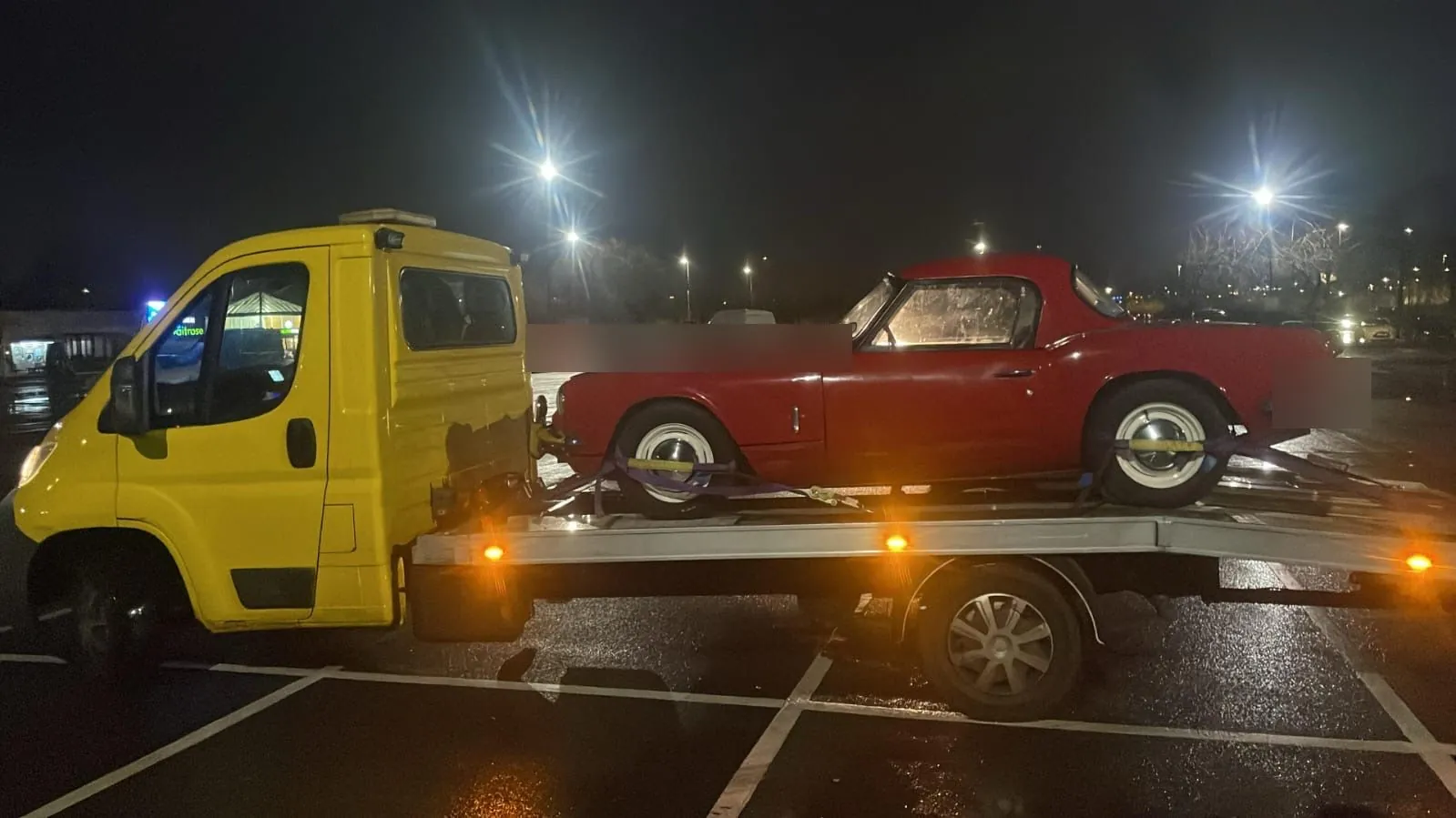 Triumph Spitfire on the yellow truck, late at night